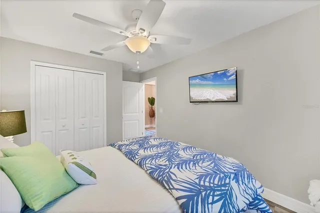 a bathroom with a granite countertop sink a toilet a mirror and shower