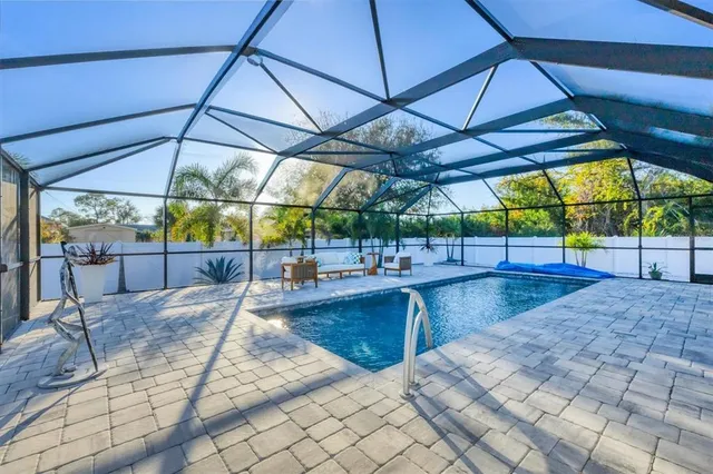 a view of a patio with table and chairs under an umbrella