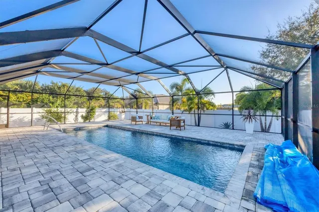 a view of a patio with a table and chairs under an umbrella