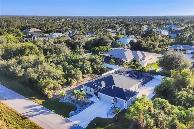 an aerial view of a house with a swimming pool