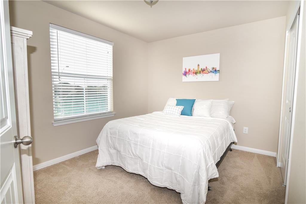 18405 Congaree Street Pflugerville, TX 78660 - Photo 12 of 26 a bedroom with a bed and a window