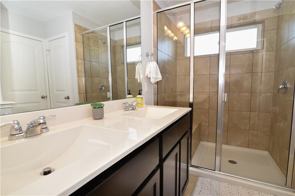 18405 Congaree Street Pflugerville, TX 78660 - Photo 20 of 26 a bathroom with a sink and a mirror