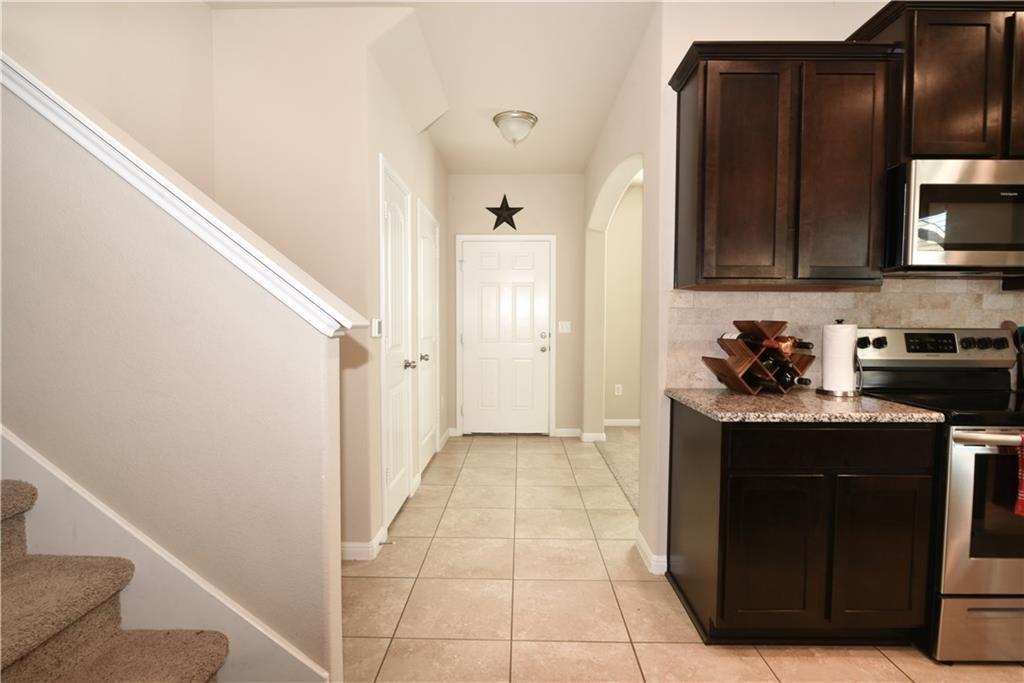 18405 Congaree Street Pflugerville, TX 78660 - Photo 6 of 26 a kitchen with a refrigerator and a stove top oven