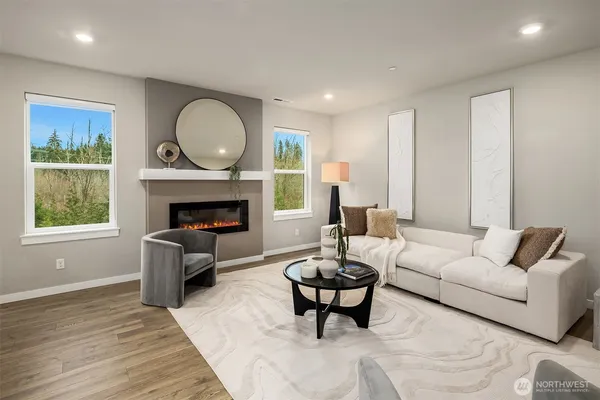 a living room with furniture fireplace and window