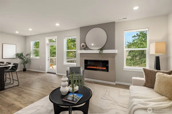 a living room with furniture fireplace and window