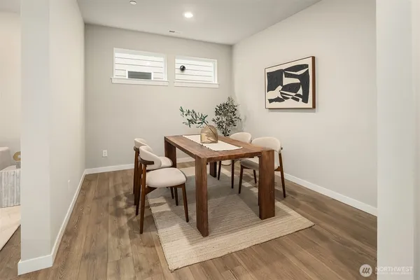 a view of a dining room with furniture and wooden floor