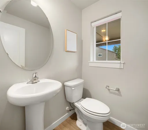 a bathroom with a toilet sink and mirror