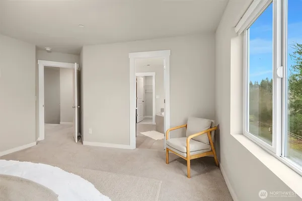 a living room with a bed and a window