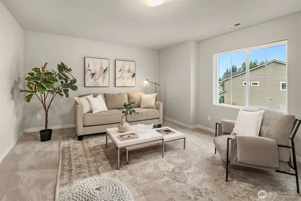 a living room with furniture and a potted plant