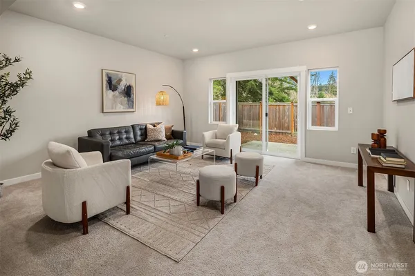 a living room with furniture and large windows