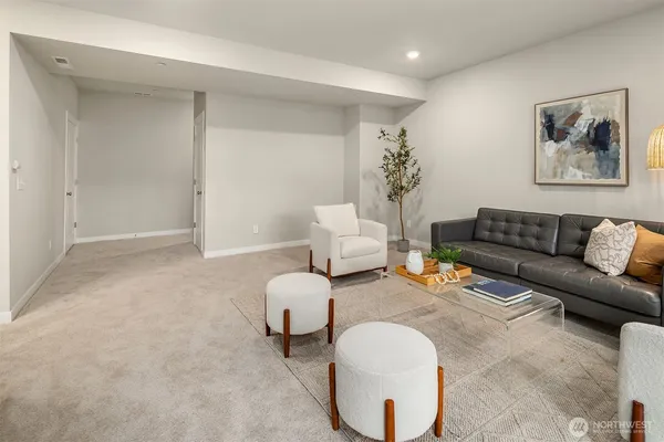 a living room with furniture and a potted plant
