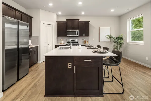 a kitchen with a sink cabinets and stainless steel appliances
