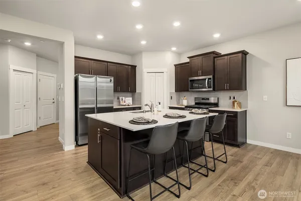 a kitchen with stainless steel appliances a sink stove and refrigerator