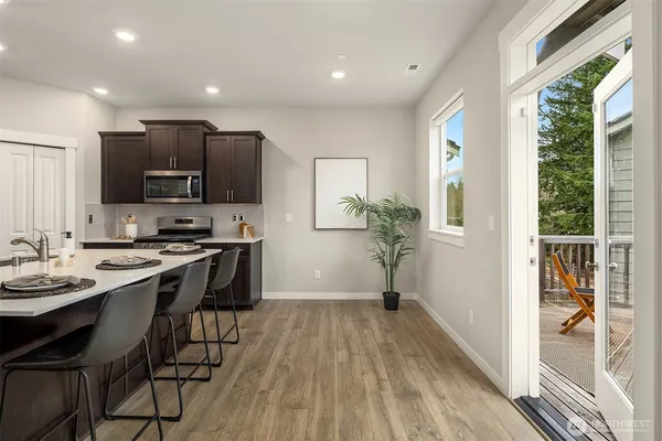 a kitchen with cabinets a sink and wooden floor