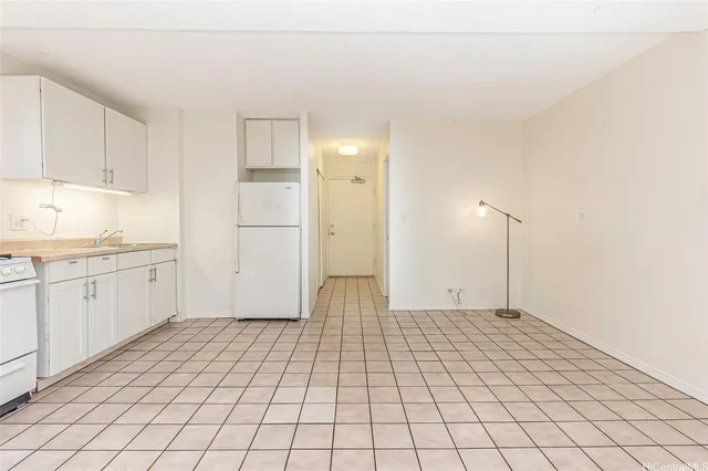 a view of a kitchen with white cabinets