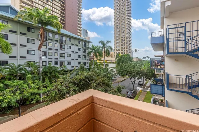 a view of a balcony with potted plants