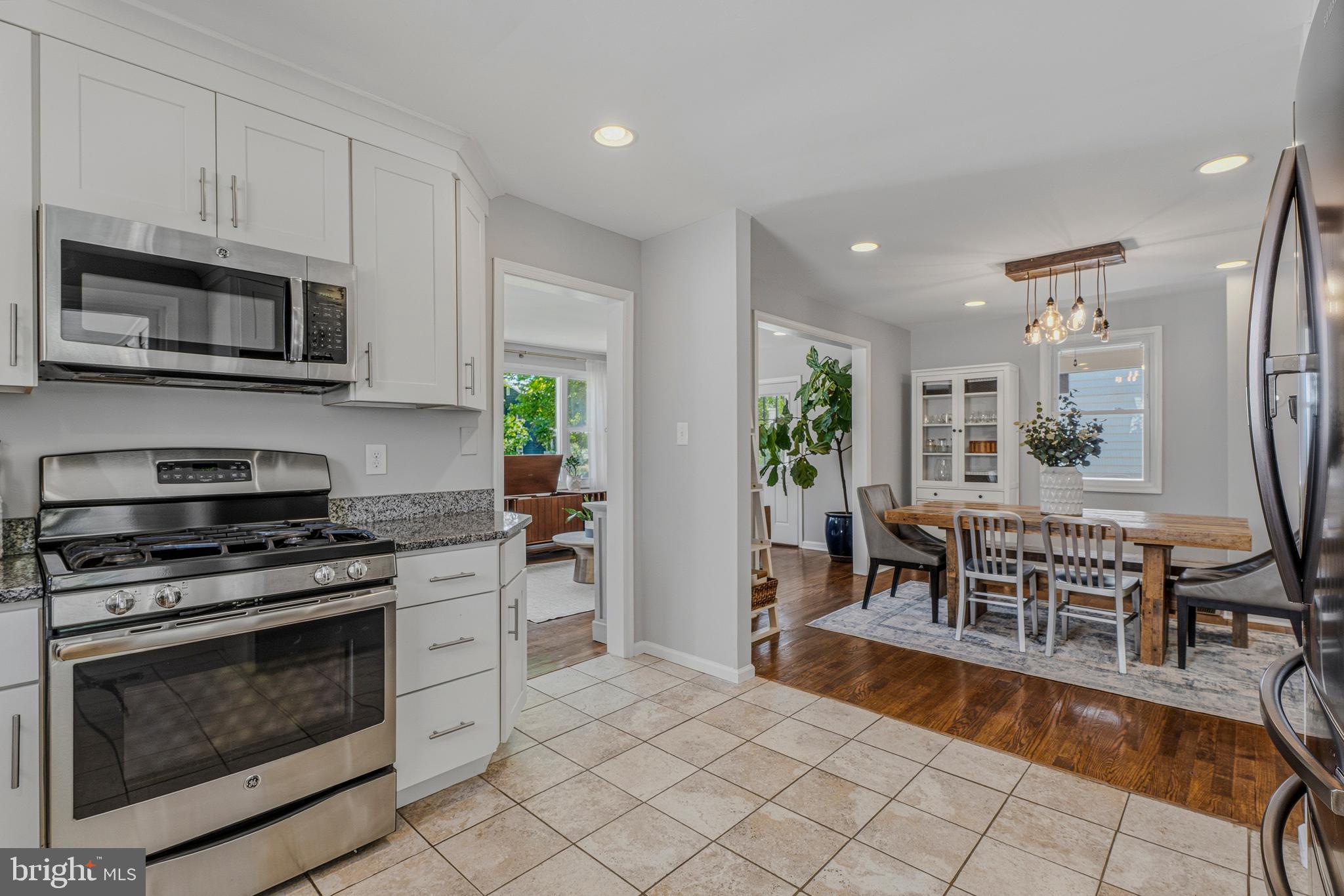 506 Brook Road Baltimore, MD 21286 - Photo 11 of 56 a kitchen with stainless steel appliances a stove a sink a microwave a dining table and chairs