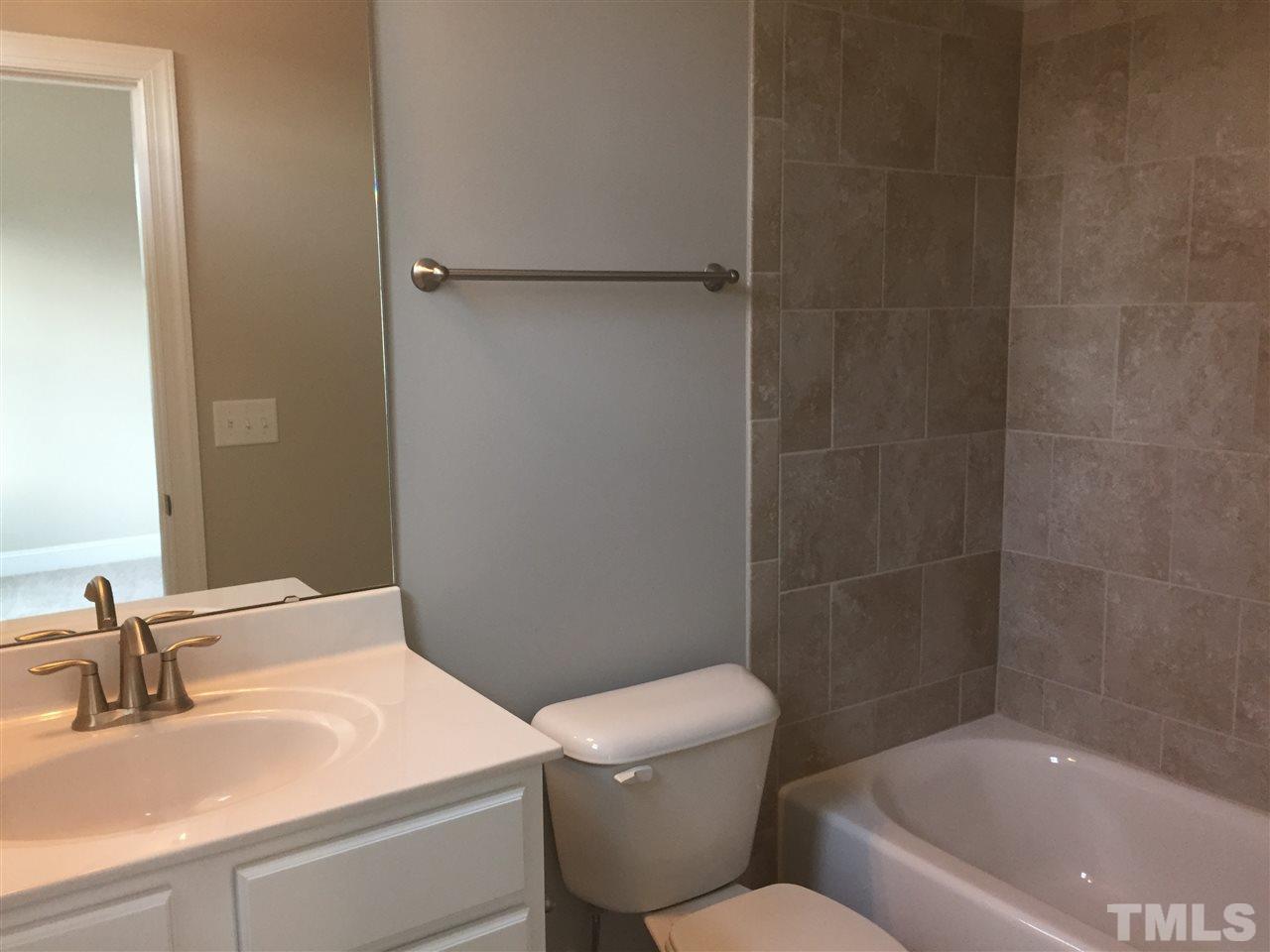 1076 Mills Street Raleigh, NC 27608 - Photo 16 of 16 a bathroom with a sink toilet and shower