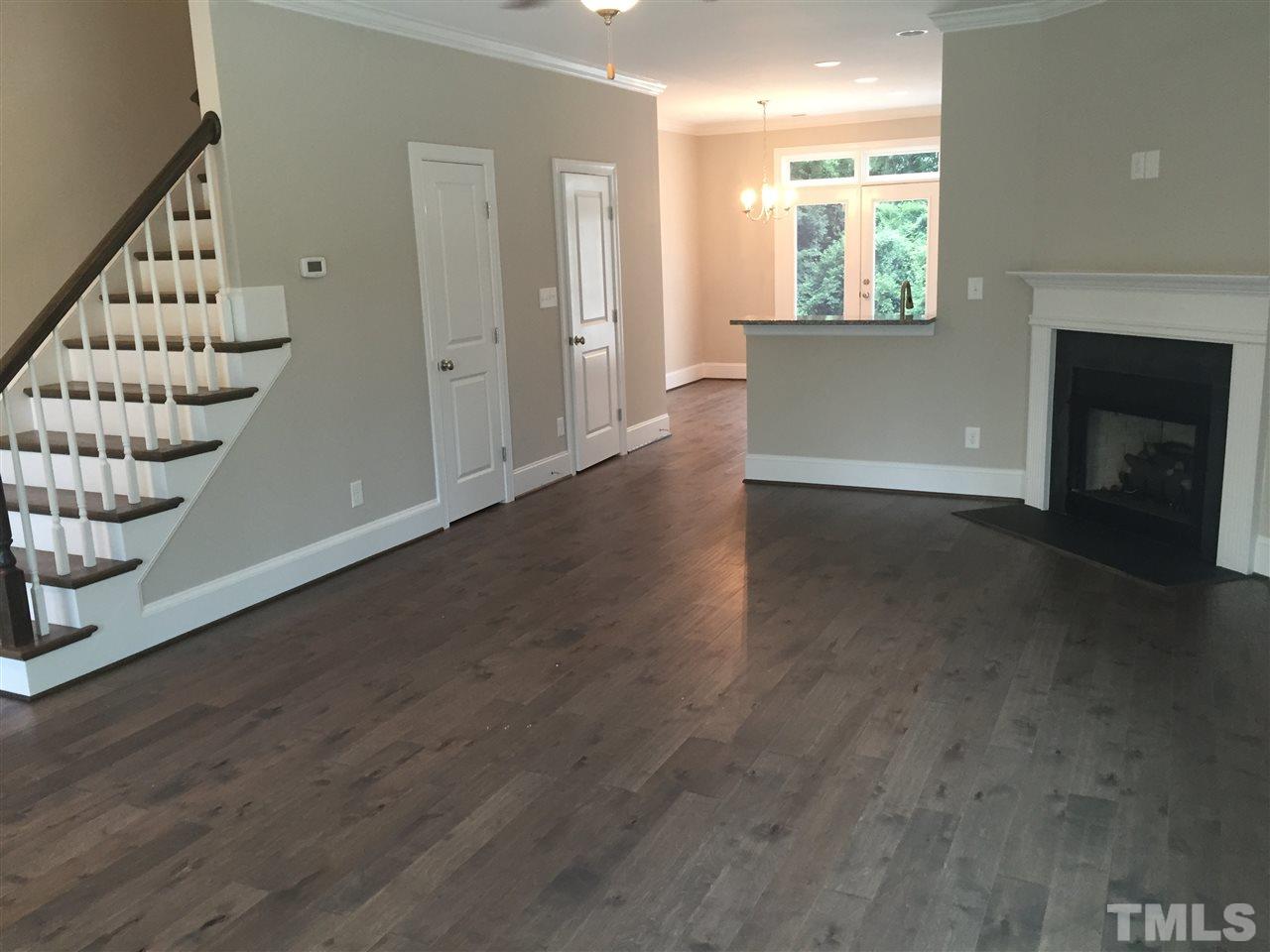 1076 Mills Street Raleigh, NC 27608 - Photo 6 of 16 an empty room with windows and fireplace