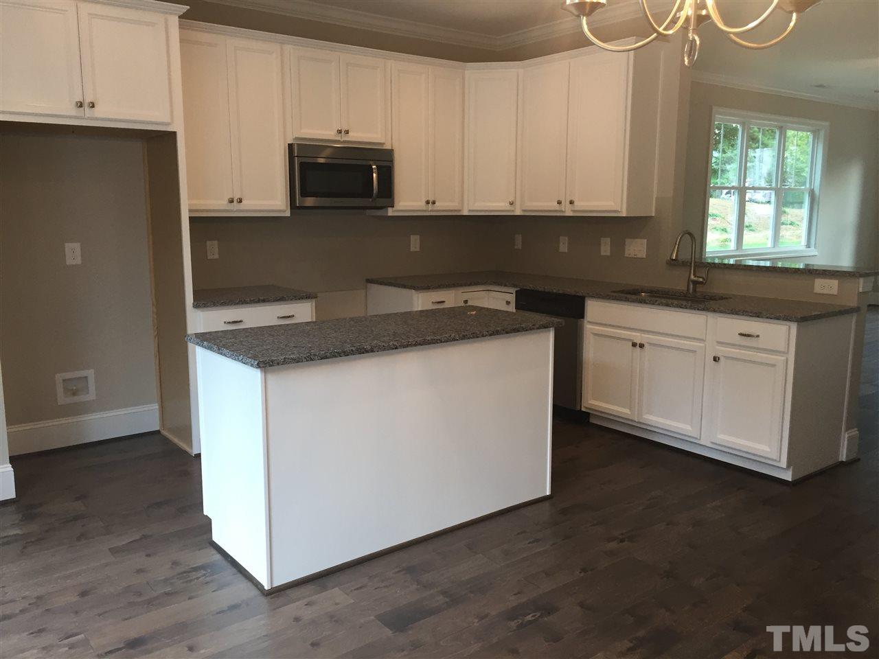 1076 Mills Street Raleigh, NC 27608 - Photo 8 of 16 a kitchen with granite countertop white cabinets and black appliances