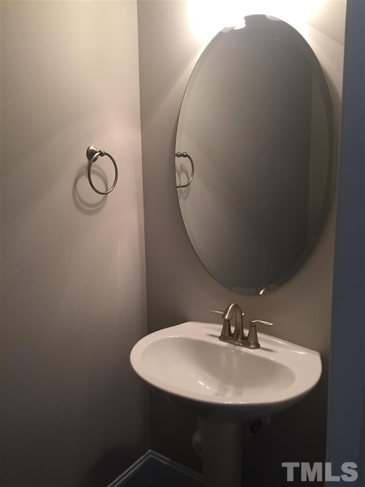 1076 Mills Street Raleigh, NC 27608 - Photo 9 of 16 a bathroom with a sink and mirror