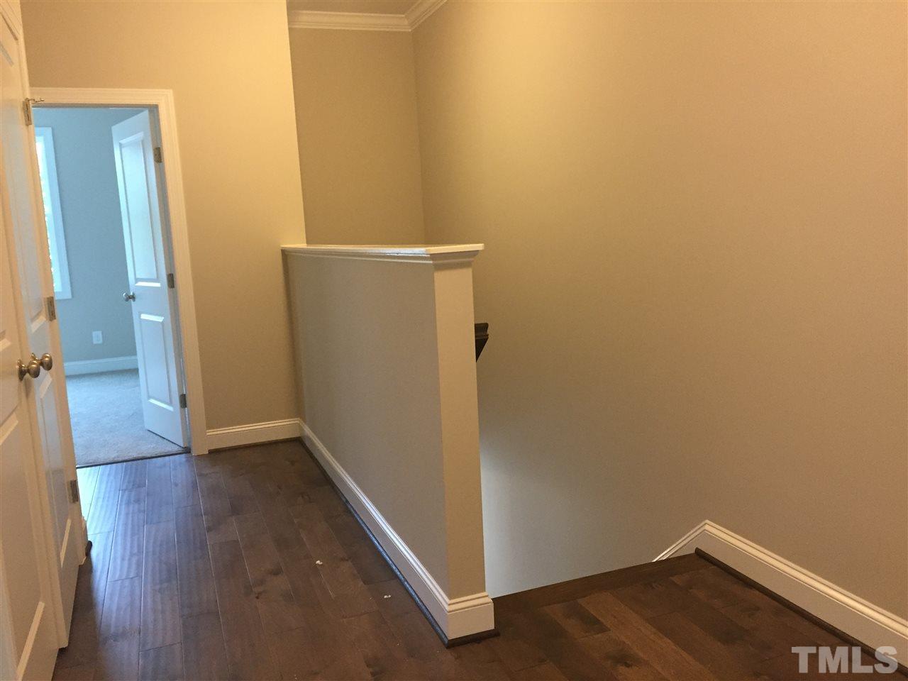 1076 Mills Street Raleigh, NC 27608 - Photo 10 of 16 an empty room with wooden floor