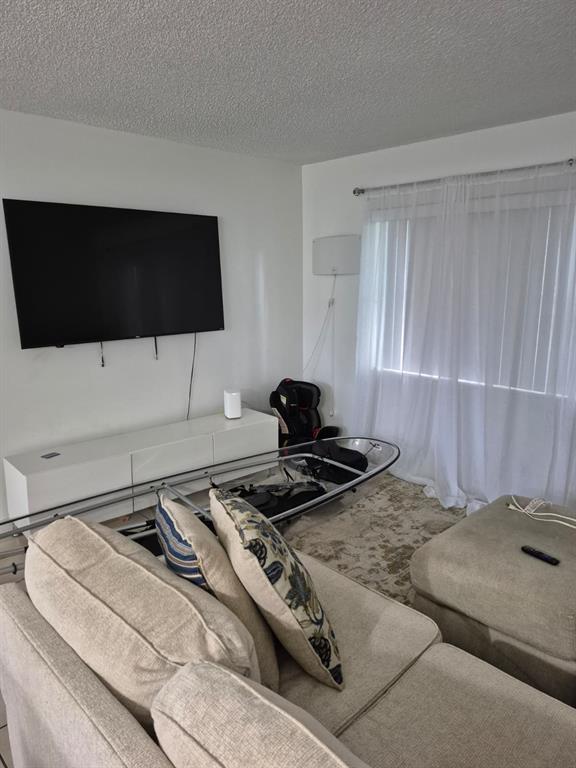 560 Southeast 2nd Avenue, Unit H2 Deerfield Beach, FL 33441 - Photo 12 of 23 a bedroom with a bed and a flat screen tv
