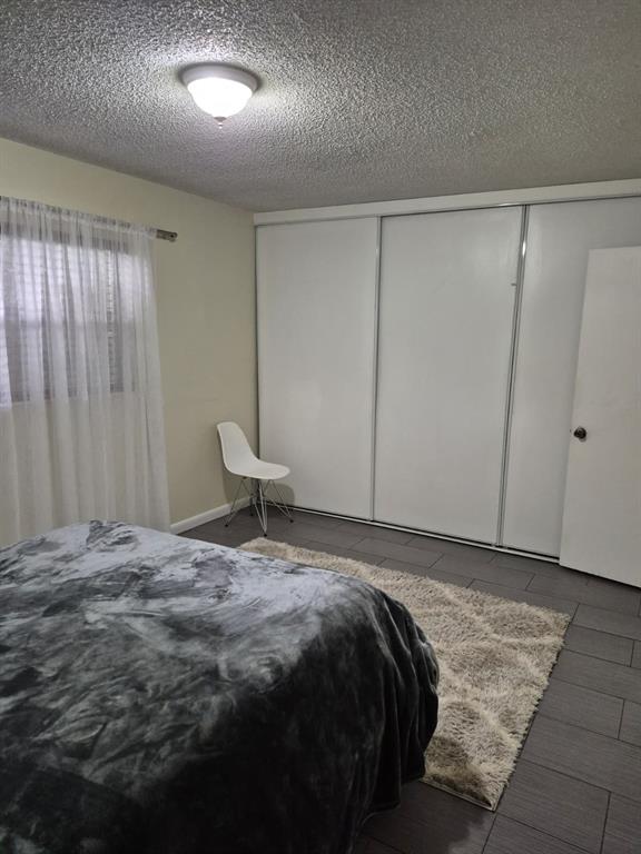 560 Southeast 2nd Avenue, Unit H2 Deerfield Beach, FL 33441 - Photo 16 of 23 a bedroom with a bed and a window