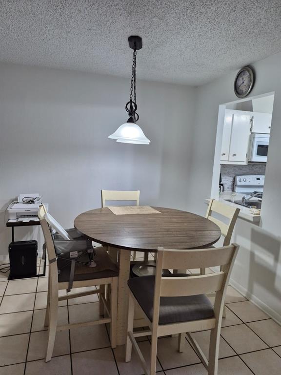 560 Southeast 2nd Avenue, Unit H2 Deerfield Beach, FL 33441 - Photo 17 of 23 a view of a dining room with furniture and a chandelier