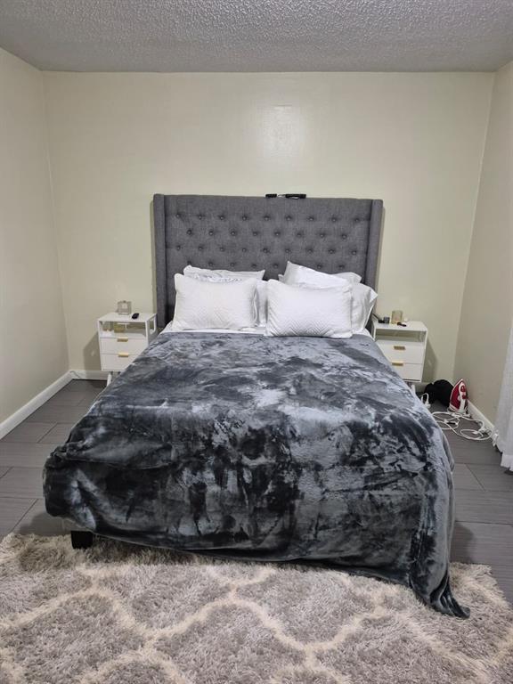 560 Southeast 2nd Avenue, Unit H2 Deerfield Beach, FL 33441 - Photo 19 of 23 a bed sitting in a bedroom next to a window