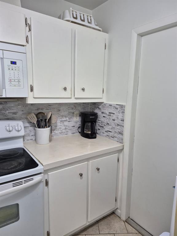 560 Southeast 2nd Avenue, Unit H2 Deerfield Beach, FL 33441 - Photo 4 of 23 a kitchen with white cabinets and white appliances