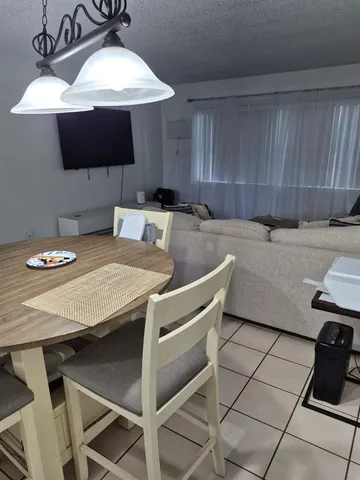 a kitchen with a table chairs and a stove