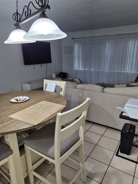 560 Southeast 2nd Avenue, Unit H2 Deerfield Beach, FL 33441 - Photo 10 of 23 a kitchen with a table chairs and a stove