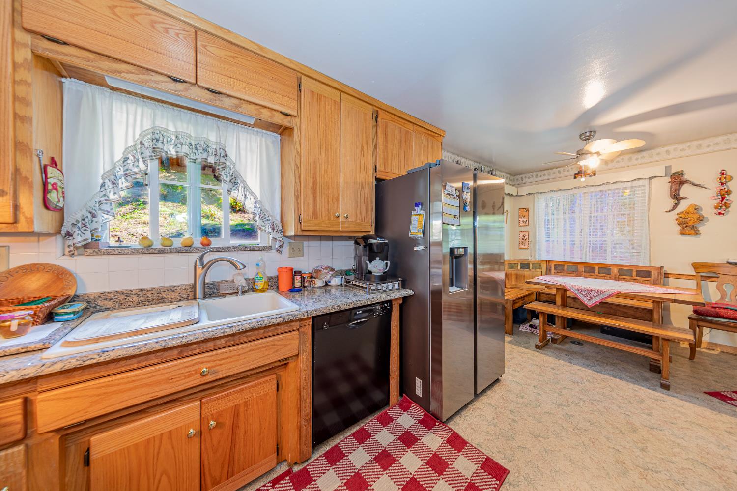 42585 Buckeye Road Oakhurst, CA 93644 - Photo 12 of 55 a kitchen with stainless steel appliances granite countertop a sink stove and refrigerator