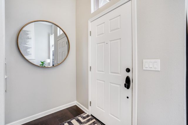 an entryway with wooden floor