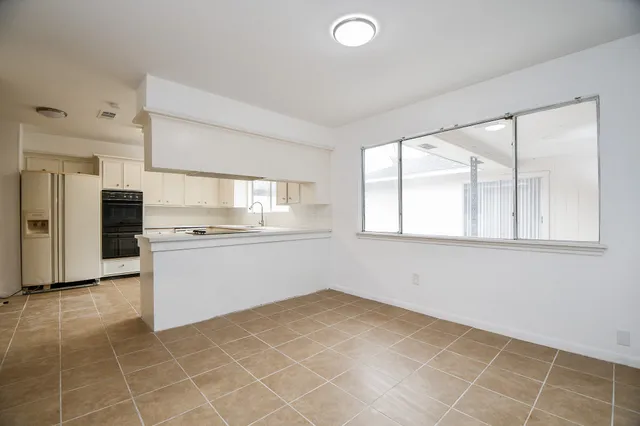 a view of a kitchen with a sink dishwasher and a refrigerator