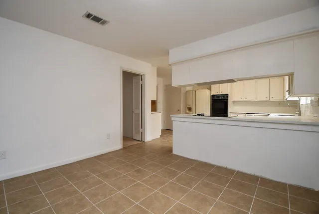 a view of a kitchen with an empty space and window
