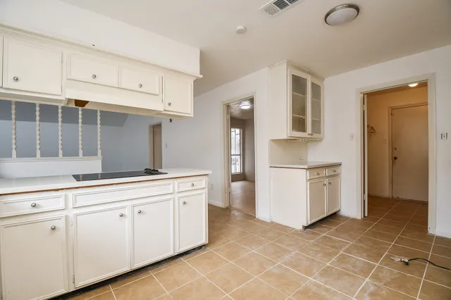 a kitchen with a cabinets and white appliances