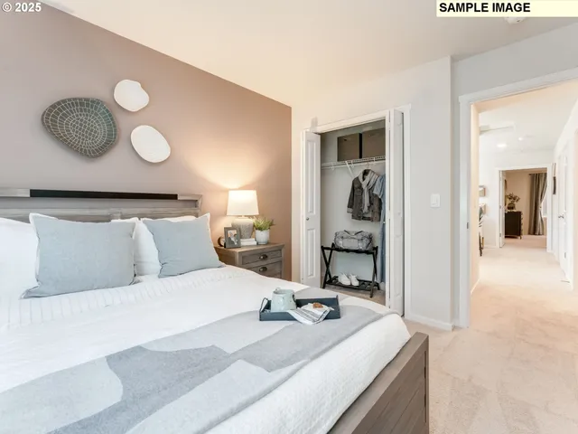 a bedroom with a bed and lamp