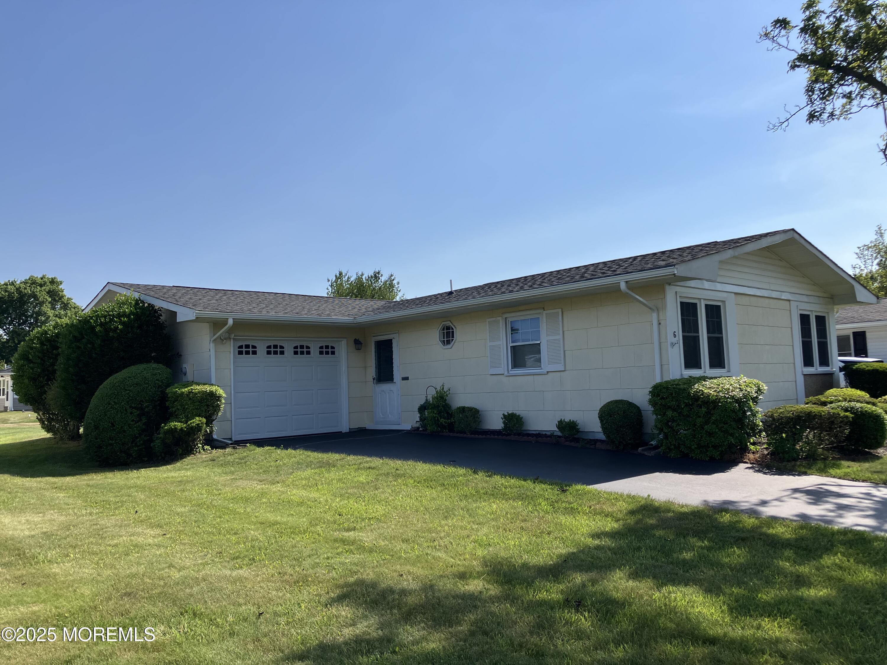 Undisclosed Address Brick, NJ 08724 - Photo 1 of 13 a front view of a house with a garden and plants