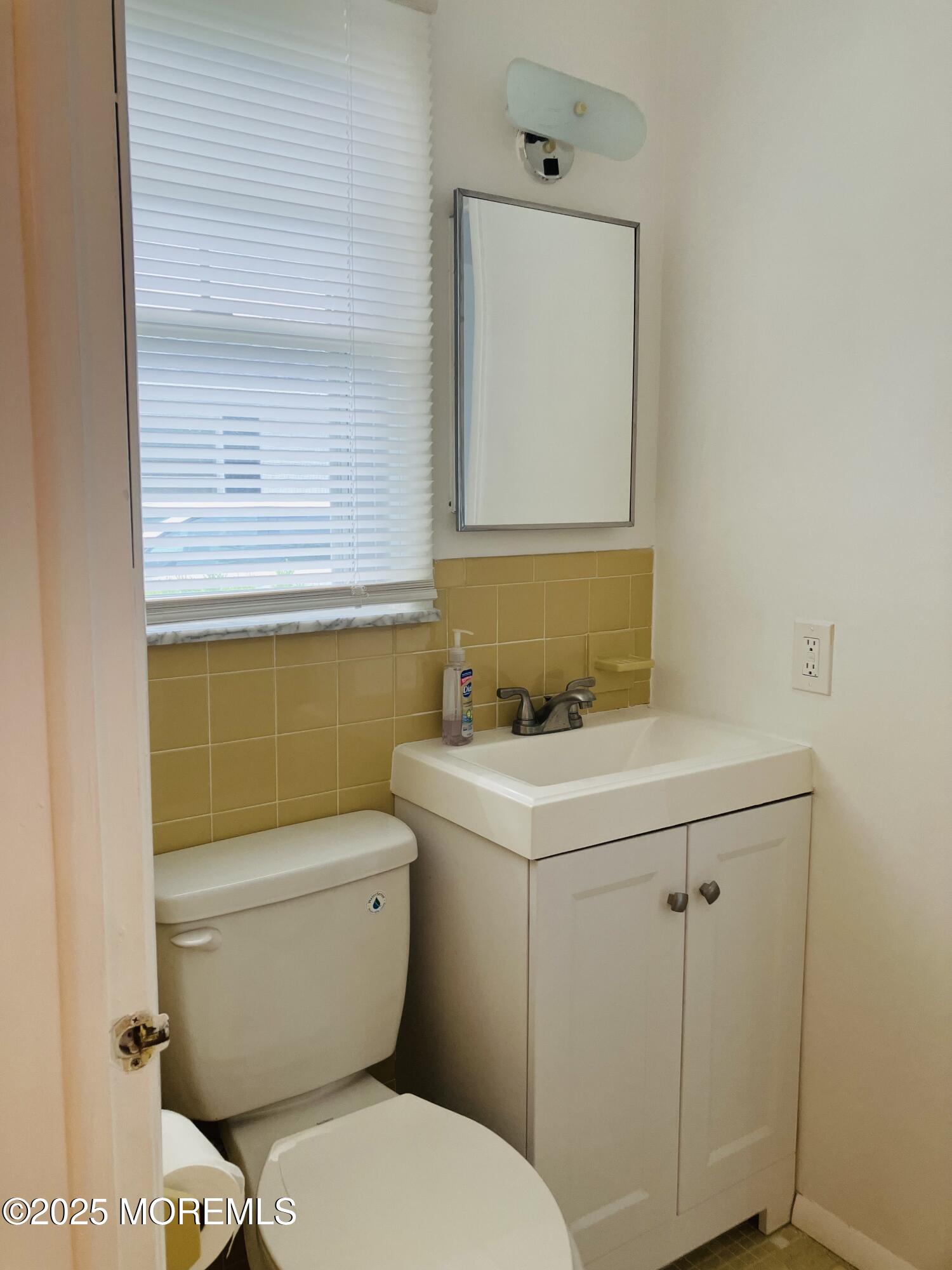 Undisclosed Address Brick, NJ 08724 - Photo 11 of 13 a bathroom with a toilet sink and mirror