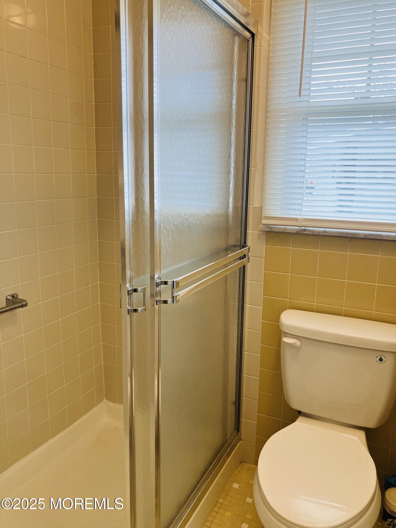 Undisclosed Address Brick, NJ 08724 - Photo 10 of 13 a white toilet sitting next to a shower