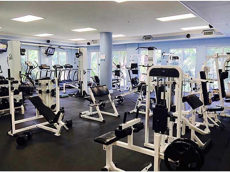 5091 Northwest 7th Street, Unit 403 Miami, FL 33126 - Photo 3 of 4 a view of a room with gym equipment