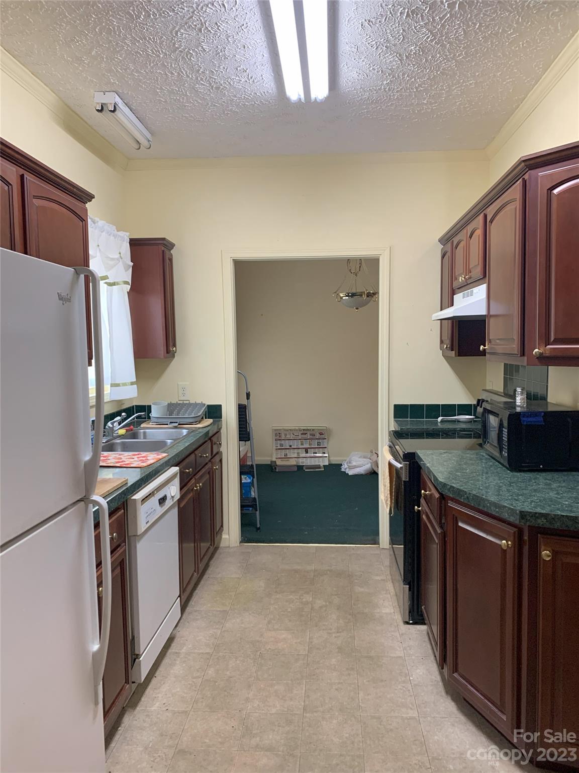 6417 Miller Road Kannapolis, NC 28081 - Photo 16 of 29 a kitchen with stainless steel appliances granite countertop a stove top oven a sink a refrigerator and a cabinets