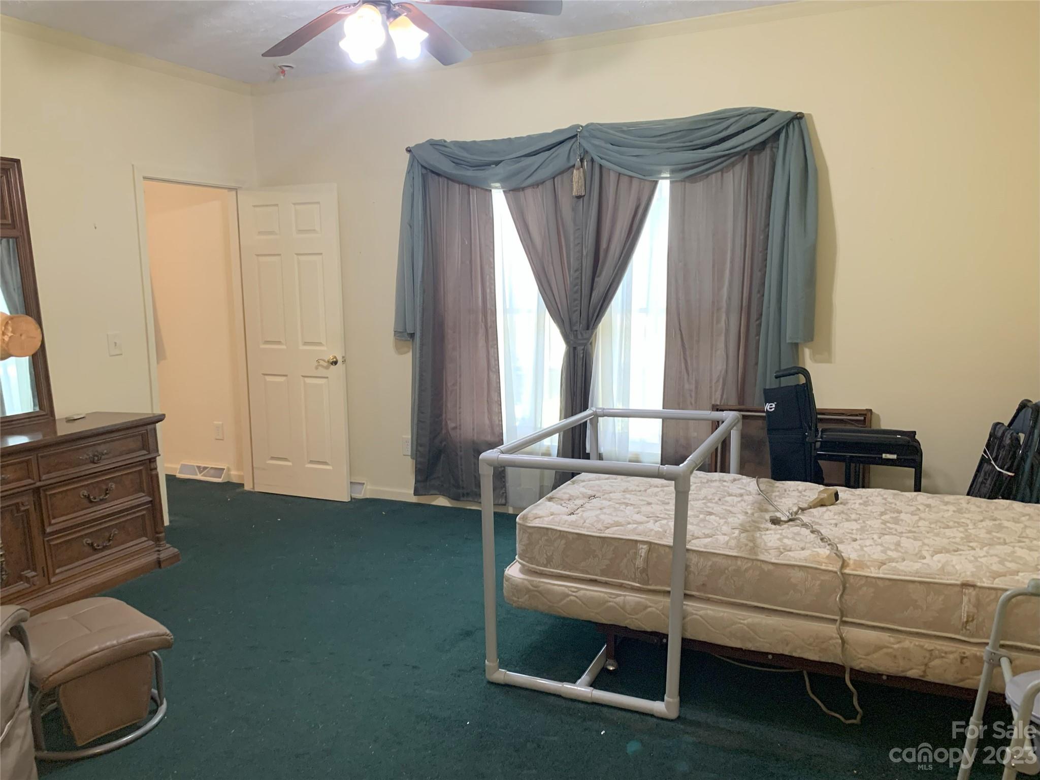 6417 Miller Road Kannapolis, NC 28081 - Photo 19 of 29 a bedroom with a bed and a chandelier