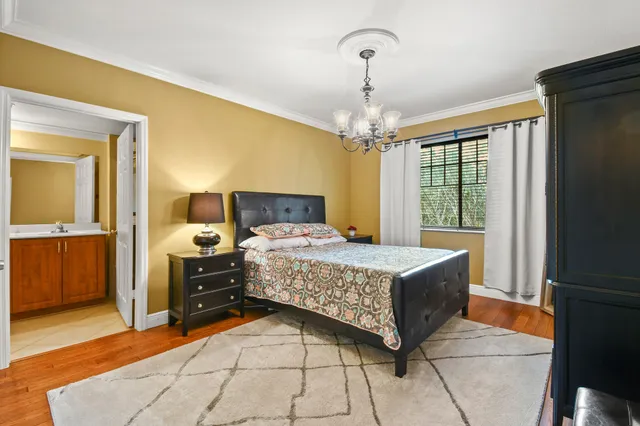 a bedroom with a bed and a chandelier