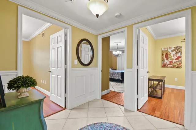 a living room with furniture a flat screen tv and a clock