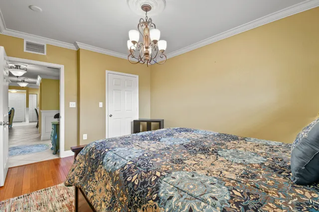 a bedroom with a bed and a chandelier