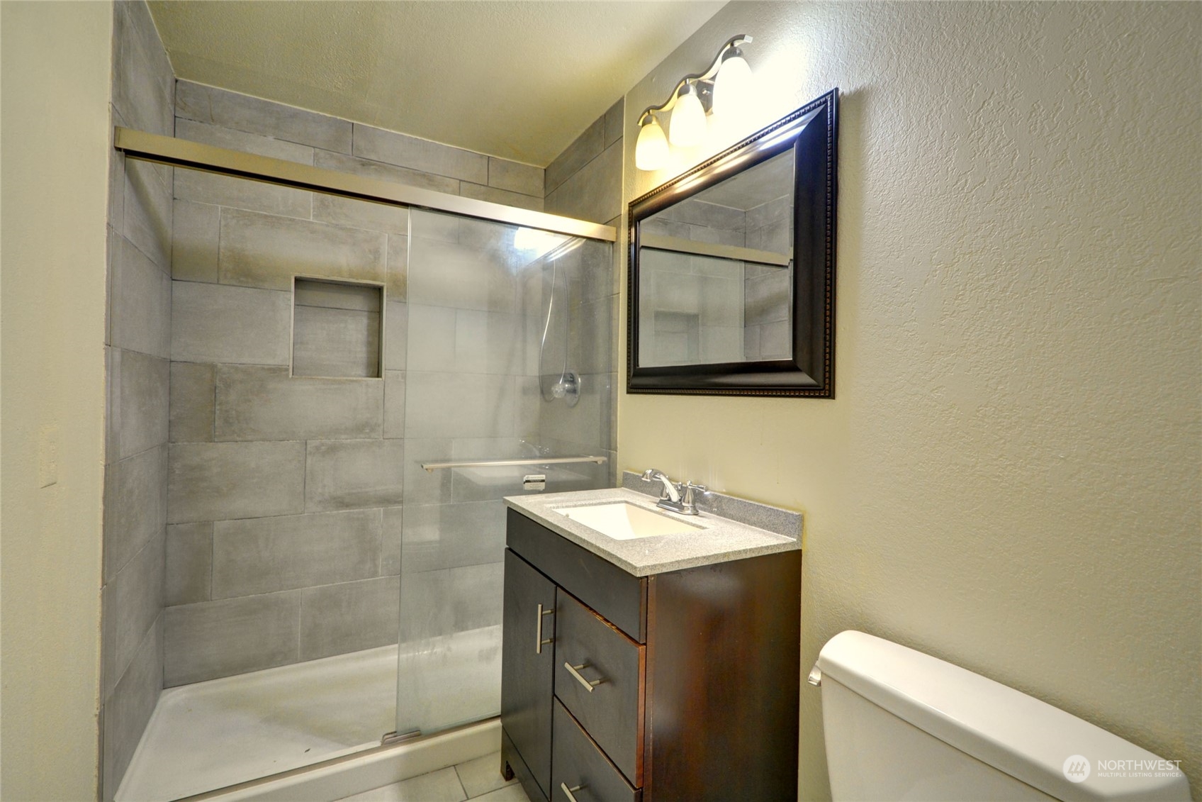 16913 29th Drive Southeast Bothell, WA 98012 - Photo 12 of 17 a bathroom with a sink a toilet and a shower