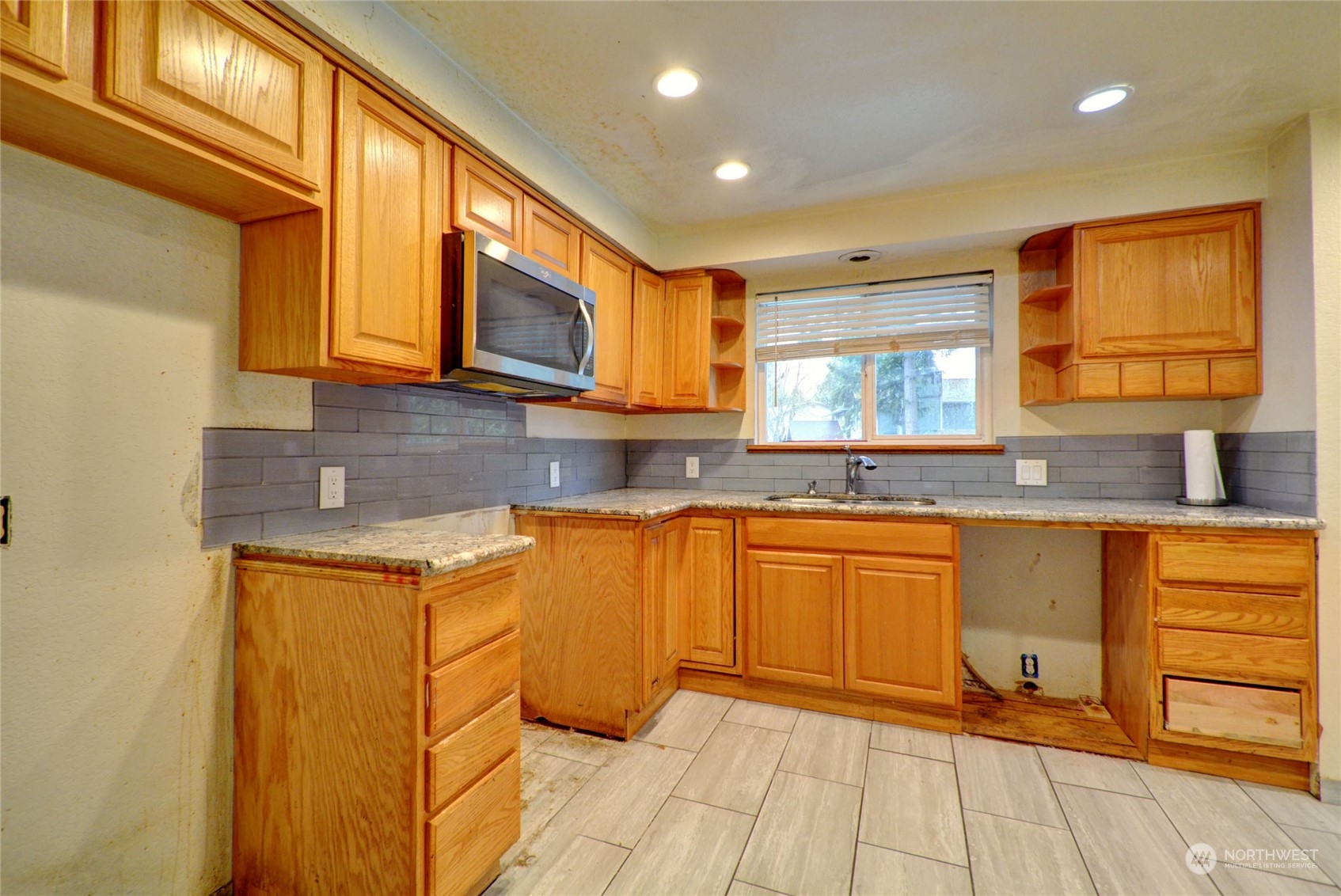 16913 29th Drive Southeast Bothell, WA 98012 - Photo 3 of 17 a kitchen with stainless steel appliances granite countertop a sink and cabinets
